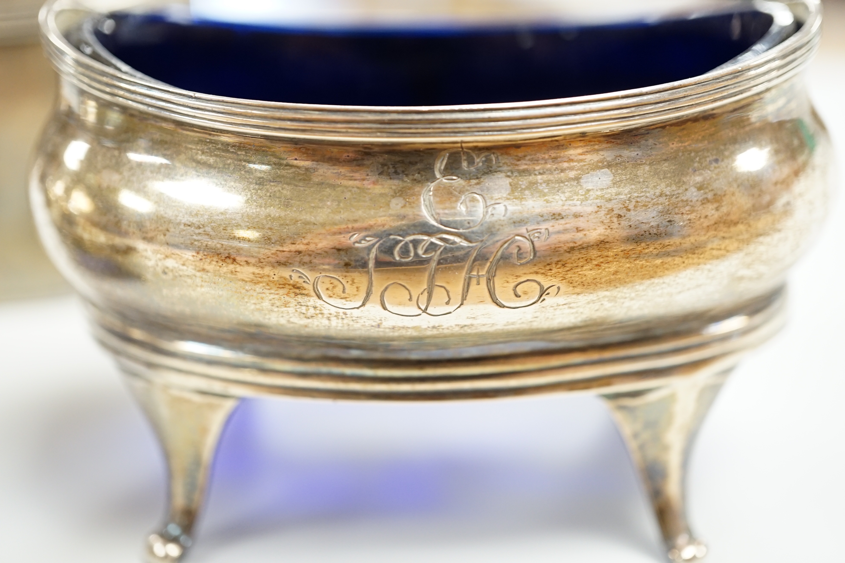 A pair of George III silver oval salts, on splayed legs, Soloman Hougham, London, 1812, length 89mm, together with a George III silver oval mustard pot, Abstinando King, London, 1797.